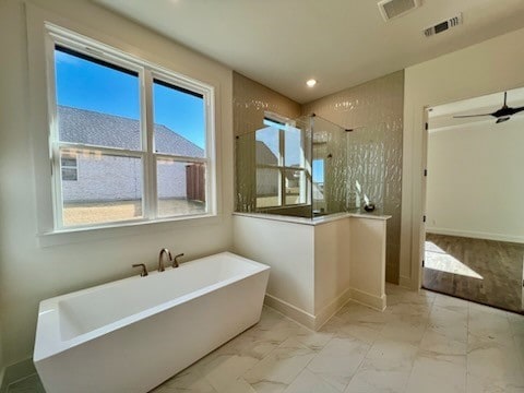 bathroom featuring ceiling fan and shower with separate bathtub