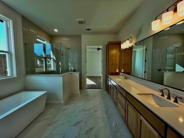 bathroom featuring ceiling fan, vanity, and independent shower and bath