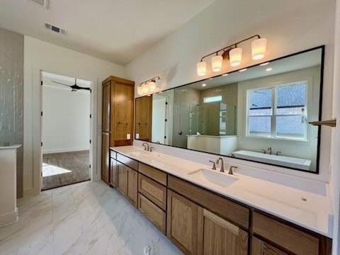 bathroom featuring plus walk in shower, vanity, and ceiling fan