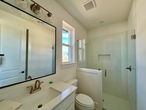 bathroom with vanity, toilet, and walk in shower