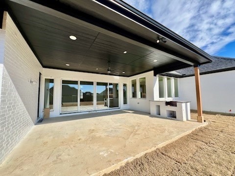 back of property featuring a patio area and ceiling fan