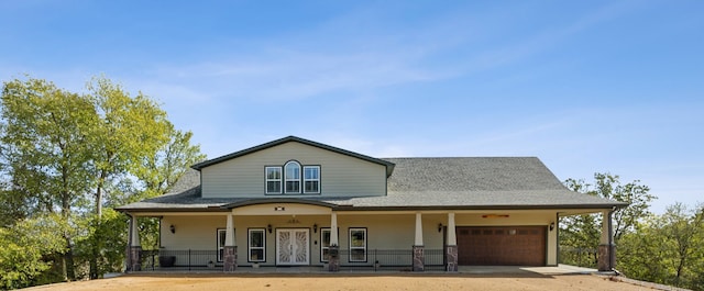 farmhouse with covered porch and a garage