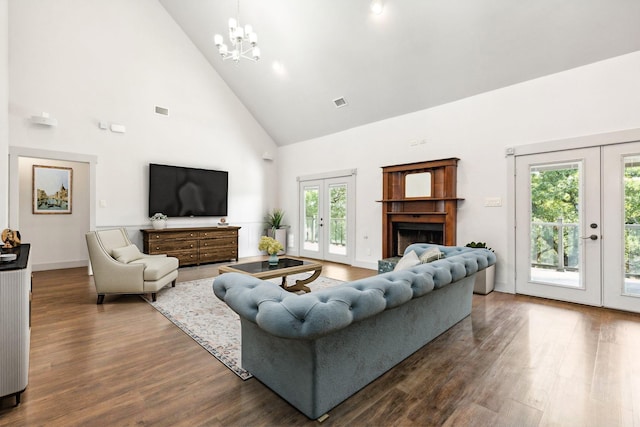 living room featuring a chandelier, french doors, high vaulted ceiling, and dark wood-type flooring