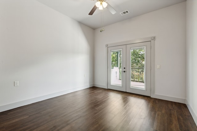 empty room featuring ceiling fan, french doors, and dark hardwood / wood-style floors