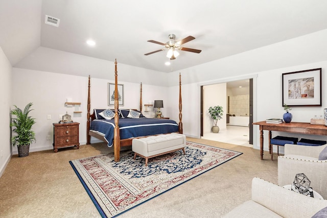 bedroom with ceiling fan, lofted ceiling, and connected bathroom