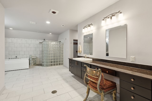 bathroom featuring tile patterned floors, vanity, and separate shower and tub