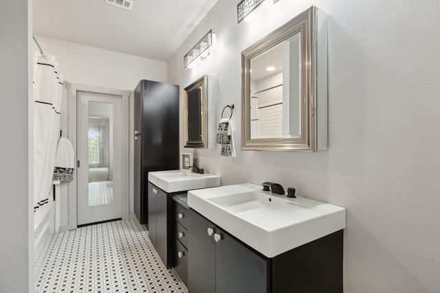 16 Hidden Valley Airpark, Shady Shores, TX 76208 - bathroom with tile patterned floors and two vanities