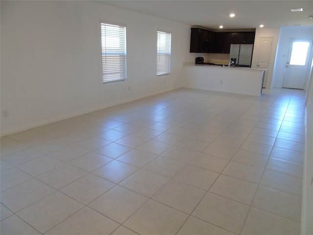 unfurnished living room with light tile patterned floors