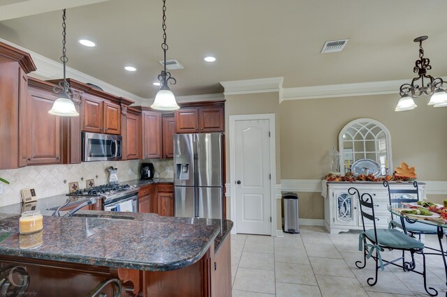 kitchen featuring pendant lighting, crown molding, appliances with stainless steel finishes, light tile patterned flooring, and kitchen peninsula