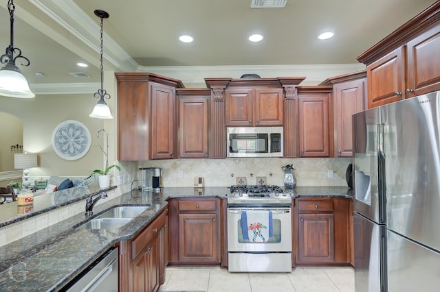 kitchen with appliances with stainless steel finishes, decorative light fixtures, ornamental molding, and sink