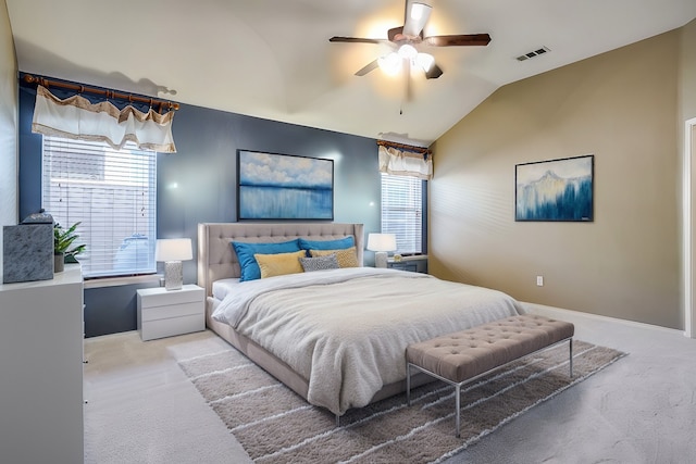 carpeted bedroom with multiple windows, ceiling fan, and vaulted ceiling