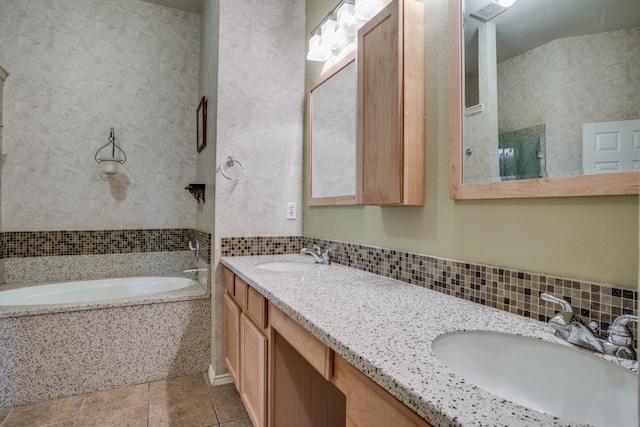 bathroom with a bath, vanity, and tile patterned floors