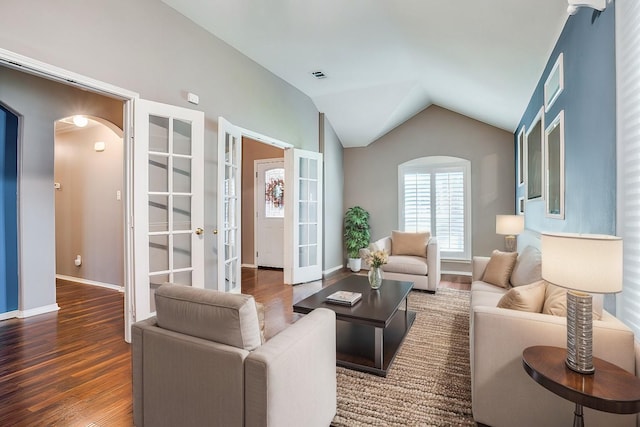 living room with french doors, dark hardwood / wood-style floors, and lofted ceiling