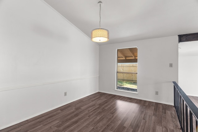 spare room with dark hardwood / wood-style flooring and ornamental molding