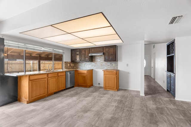 kitchen featuring light stone counters, dishwasher, sink, backsplash, and extractor fan