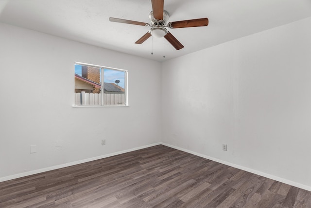 empty room featuring ceiling fan and dark hardwood / wood-style floors