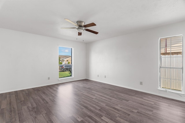 unfurnished room with dark wood-type flooring and ceiling fan