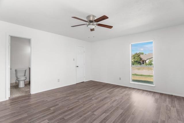 spare room with dark hardwood / wood-style flooring and ceiling fan