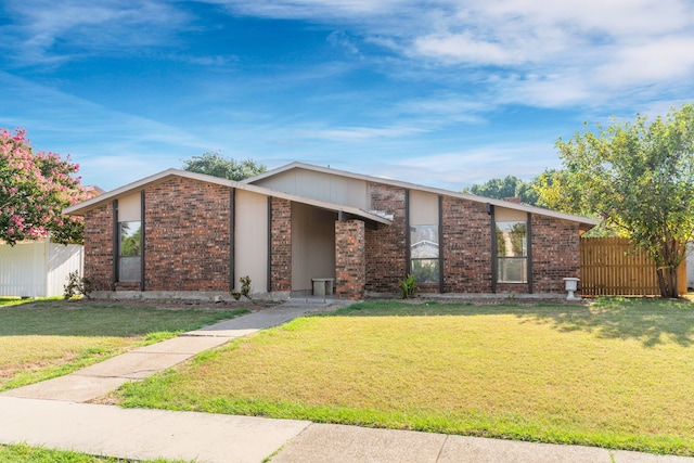 ranch-style home featuring a front yard