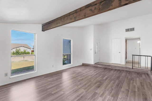 interior space featuring wood-type flooring and vaulted ceiling with beams