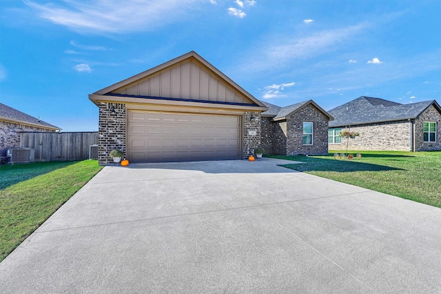 view of front of property with a front lawn, central AC unit, and a garage