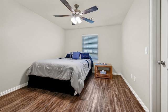 bedroom with dark hardwood / wood-style floors and ceiling fan