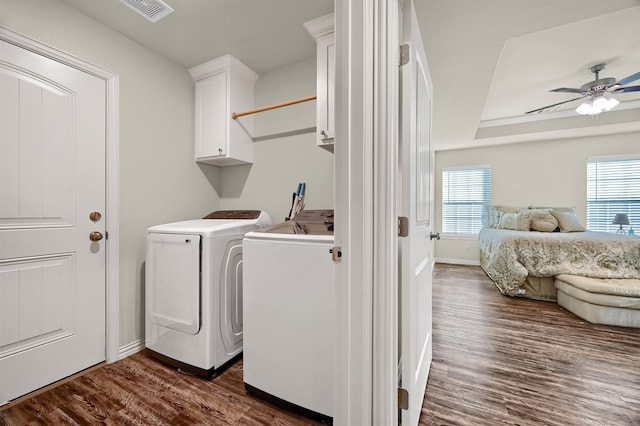 laundry room with dark hardwood / wood-style floors, ceiling fan, cabinets, and separate washer and dryer