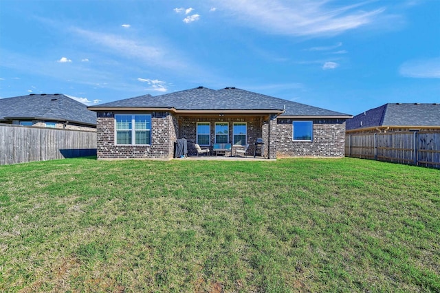 rear view of house featuring a lawn and a patio