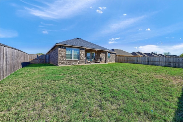 back of house with a lawn