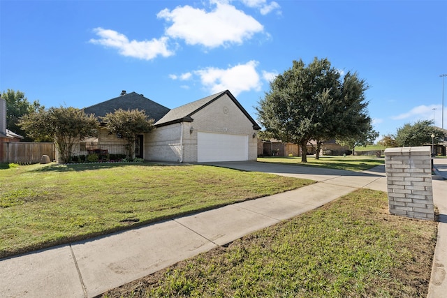 ranch-style house featuring a front lawn and a garage