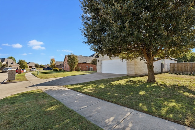 obstructed view of property featuring a garage and a front lawn