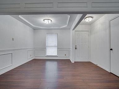 empty room featuring dark hardwood / wood-style flooring