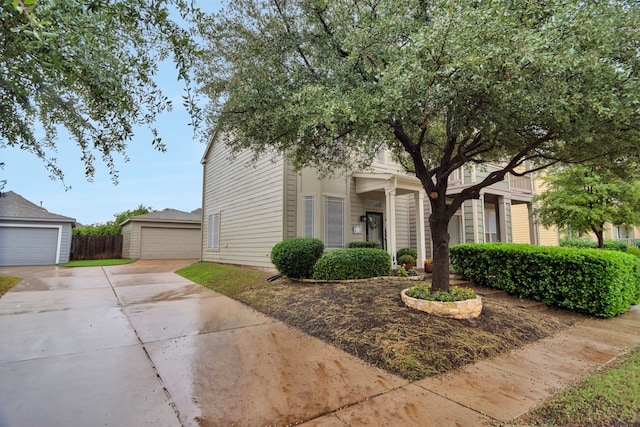 view of front of property featuring a garage and an outdoor structure