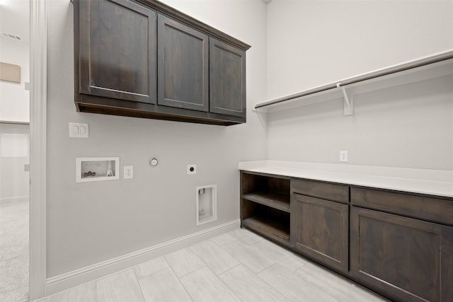 clothes washing area with hookup for a gas dryer, washer hookup, baseboards, cabinet space, and electric dryer hookup