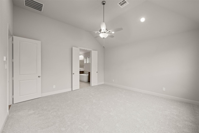 unfurnished bedroom featuring light carpet, baseboards, visible vents, and vaulted ceiling