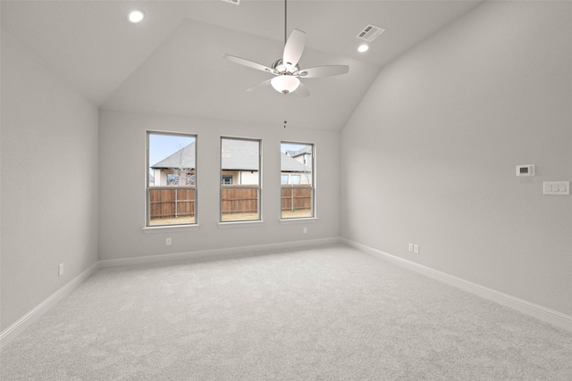 unfurnished room with baseboards, visible vents, a ceiling fan, light colored carpet, and vaulted ceiling