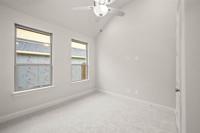 unfurnished room featuring carpet floors, vaulted ceiling, and baseboards