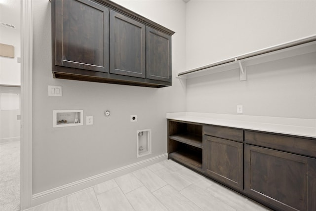 washroom with gas dryer hookup, hookup for an electric dryer, washer hookup, baseboards, and cabinet space