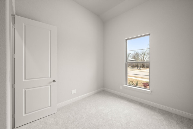 empty room with baseboards and light colored carpet