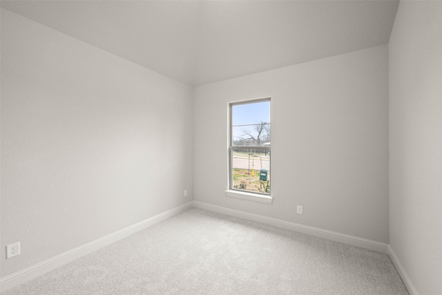 unfurnished room featuring carpet floors and baseboards