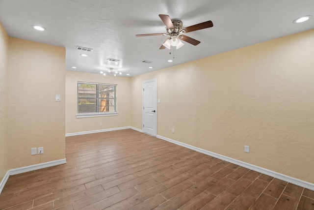 spare room with hardwood / wood-style floors and ceiling fan