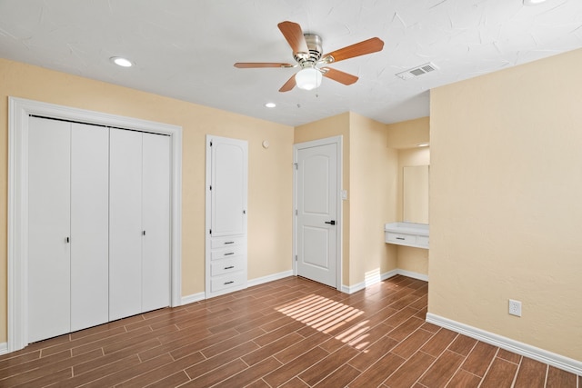 unfurnished bedroom featuring ceiling fan and dark hardwood / wood-style flooring