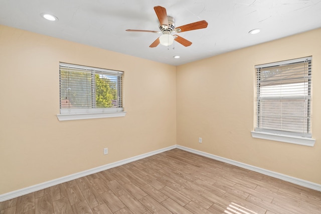 spare room featuring light wood-type flooring and ceiling fan