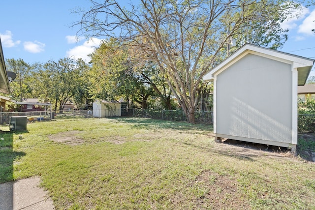 view of yard with central air condition unit and a shed