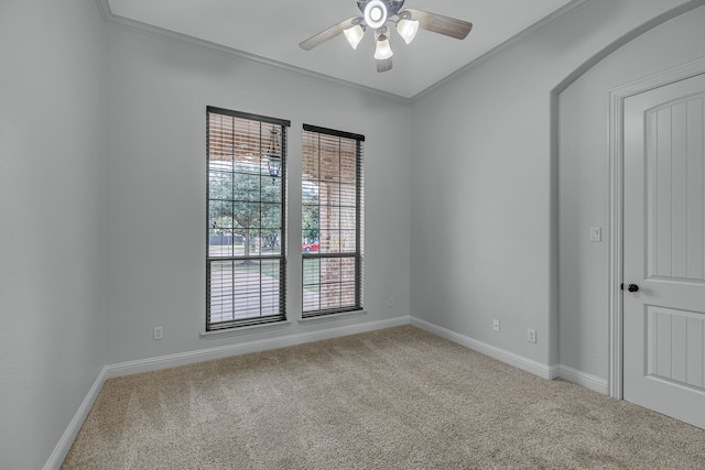 unfurnished room with ceiling fan, ornamental molding, and carpet