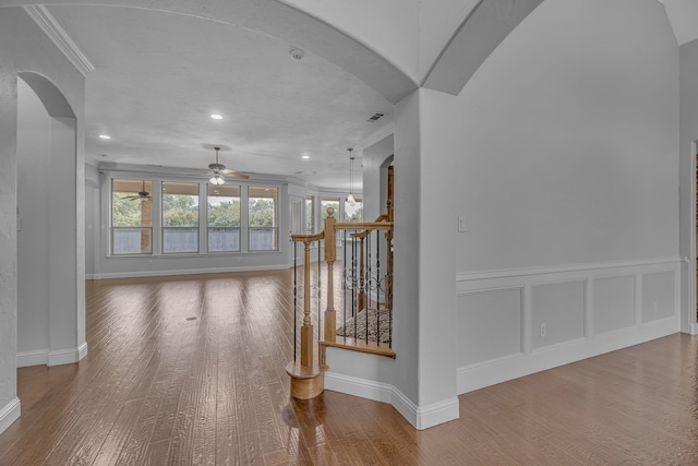 corridor featuring crown molding and hardwood / wood-style flooring