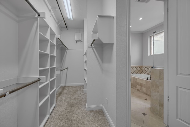 spacious closet with light colored carpet