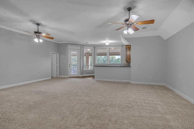 unfurnished living room featuring ornamental molding, vaulted ceiling, light colored carpet, and ceiling fan