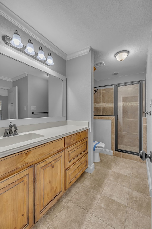 bathroom with a shower with door, ornamental molding, a textured ceiling, vanity, and tile patterned floors