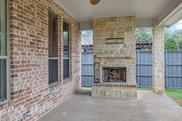 view of patio / terrace with an outdoor stone fireplace